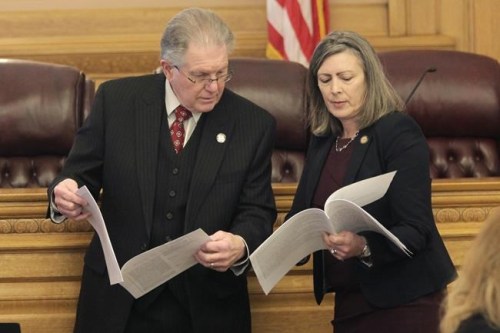 Kansas state Sen. Mike Thompson, left, R-Shawnee, confers with state Sen. Kellie Warren, R-Leawood, Wednesday, March 9, 2022, during a committee meeting at the Statehouse in Topeka, Kan. Thompson denies the link between human activity and climate change and has a key role in energy policy as the Senate Utilities Committee chairman. (AP Photo/John Hanna)