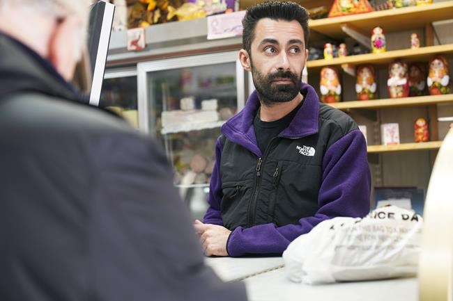 Gleb Gavrilov, owner of Moscow on the Hudson, helps a customer at his store in New York, Wednesday, March 16, 2022. Angered by the deadly violence and the humanitarian crisis resulting from Russia's war on Ukraine, some Americans are dumping their frustrations on Russian businesses and brands — or anything that sounds Russian. Business owners and experts say it's the most intense anti-Russian sentiment they've seen, but they call the behavior irrational and misplaced, especially when so many owners are denouncing Russian President Vladimir Putin's invasion, not to mention the fact that some of them are not even Russian. (AP Photo/Seth Wenig)