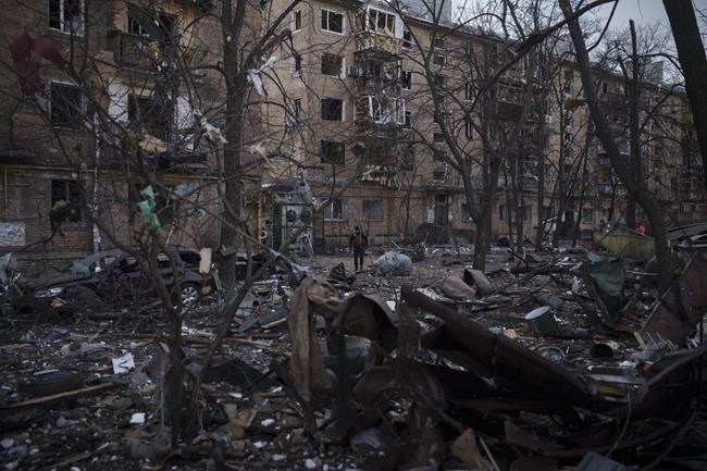 A police officer walks at the site of a bombing that damaged residential buildings in Kyiv, Ukraine, Friday, March 18, 2022. Russian forces pressed their assault on Ukrainian cities Friday, with new missile strikes and shelling on the edges of the capital Kyiv and the western city of Lviv, as world leaders pushed for an investigation of the Kremlin’s repeated attacks on civilian targets, including schools, hospitals and residential areas. (AP Photo/Felipe Dana)