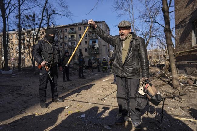 A man shouts anti Russian slogans at the site where a bombing damaged residential buildings in Kyiv, Ukraine, Friday, March 18, 2022. Russian forces pressed their assault on Ukrainian cities Friday, with new missile strikes and shelling on the edges of the capital Kyiv and the western city of Lviv, as world leaders pushed for an investigation of the Kremlin's repeated attacks on civilian targets, including schools, hospitals and residential areas. (AP Photo/Rodrigo Abd)