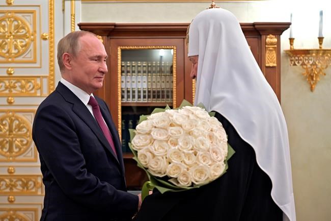 FILE - Russian President Vladimir Putin congratulates Russian Orthodox Church Patriarch Kirill on the 13th anniversary of his enthronement in Moscow, Russia, Tuesday, Feb. 1, 2022. (Alexei Nikolsky, Sputnik, Kremlin Pool Photo via AP)
