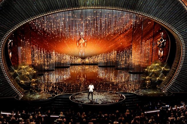 FILE - Chris Rock hosts the Oscars at the Dolby Theatre in Los Angeles on on Feb. 28, 2016. The Oscars will be held on Sunday, March 27 at the Dolby Theatre in Los Angeles. The ceremony is set to begin at 8 p.m. ET and will be broadcast live on ABC. (Photo by Chris Pizzello/Invision/AP, File)