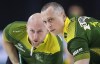 Team Northern Ontario second E.J. Harnden, right, and lead Ryan Harnden sweep while playing Team Saskatchewan during playoff action at the Tim Hortons Brier in Lethbridge, Alta., Friday, March 11, 2022. THE CANADIAN PRESS/Jeff McIntosh