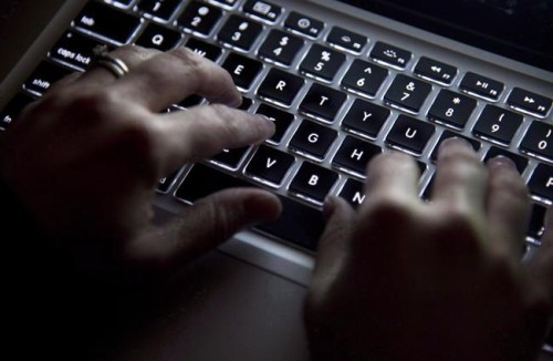A woman uses a computer keyboard in North Vancouver, B.C., on Wednesday, December, 19, 2012. An Ontario security software company says it has discovered a new affiliate of a ransomware gang that has pledged allegiance to Russia carrying out attacks with threat emulation software.THE CANADIAN PRESS/Jonathan Hayward