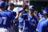 Toronto Blue Jays' Danny Jansen (9) is welcomed back to the dugout after scoring on a wild pitch in the third inning during spring training baseball game against the Baltimore Orioles, in Sarasota, Fla., Friday, March 18, 2022.The Toronto Blue Jays hit seven doubles to batter the Baltimore Orioles for a 9-5 win Friday in their Grapefruit League debut in Sarasota. THE CANADIAN PRESS/AP-Steve Helber