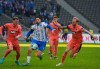 Hertha's Suat Serdar is challenged by Hoffenheim's David Raum, left, and Kevin Vogt during the Bundesliga soccer match between Hertha BSC and TSG 1899 Hoffenheim at Olympiastadion, Berlin, Saturday March 19, 2022. (Soeren Stache/dpa via AP)