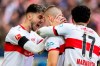 Stuttgart's Waldemar Anton, center, celebrates scoring with Atakan Karazor, left, and Omar Marmoush during the Bundesliga soccer match between VfB Stuttgart and FC Augsburg at Mercedes-Benz Arena, in Stuttgart, Germany, Saturday March 19, 2022. (Tom Weller/dpa via AP)