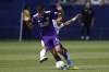 Los Angeles Galaxy midfielder Samuel Grandsir, back, defends against Orlando City defender João Moutinho (4) during the second half of an MLS soccer match in Los Angeles, Saturday, March 19, 2022. (AP Photo/Ashley Landis)
