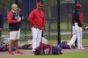 Washington Nationals general manager Mike Rizzo, left, and manager Dave Martinez, center, watch during the team's spring training baseball workout, Tuesday, March 15, 2022, in West Palm Beach, Fla. (AP Photo/Sue Ogrocki)