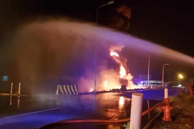 In this photo provided by the Saudi Press Agency, firefighters try to extinguish a blaze at an Aramco terminal in the southern border town of Jizan, Saudi Arabia, early Sunday, March 20, 2022. Yemen’s Houthi rebels unleashed a barrage of drone and missile strikes on Saudi Arabia early Sunday that targeted a liquified natural gas plant, water desalination plant, oil facility and power station, Saudi state-run media reported. (Saudi Press Agency via AP)