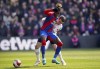 Crystal Palace's Wilfried Zaha battles with Everton's Seamus Coleman during the English FA Cup quarter final soccer match between Crystal Palace and Everton at Selhurst Park, London, Sunday, March 20, 2022. (John Walton/PA via AP)