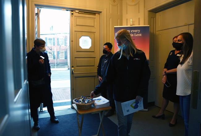 Yale University faculty and staff welcome students and community members to a benefit concert for Ukraine at St. Thomas More Catholic chapel in New Haven, Conn., Wednesday, March 16, 2022. The performance raised funds to help the people of Ukraine and also aimed to bring comfort to people feeling helpless during a time of crisis. (AP Photo/Jessie Wardarski)