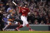 FILE - Boston Red Sox's Kyle Schwarber hits a grand slam home run against the Houston Astros during the second inning in Game 3 of baseball's American League Championship Series Monday, Oct. 18, 2021, in Boston. Kyle Schwarber is coming to Philadelphia, agreeing Wednesday, March 16, 2022, to a four-year deal with the Phillies worth about $80 million, a person familiar with the negotiations told The Associated Press.(AP Photo/David J. Phillip, File)