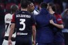 A.C. Milan goalkeeper Mike Maignan, center exchanges words with Cagliari's Leonardo Pavoletti, right, at a Serie A soccer match Saturday, March 19, 2022, in Cagliari, Italy. (Tocco Alessandro/LaPresse via AP)/LaPresse via AP)