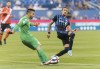 Montreal Impact's Maximiliano Urruti moves in on Cavalry FC goalkeeper Marco Carducci during first half semi-final Canadian championship soccer action in Montreal, Wednesday, August 7, 2019. Cavalry FC goalkeeper Marco Carducci has revealed he is recovering from testicular cancer. THE CANADIAN PRESS/Graham Hughes