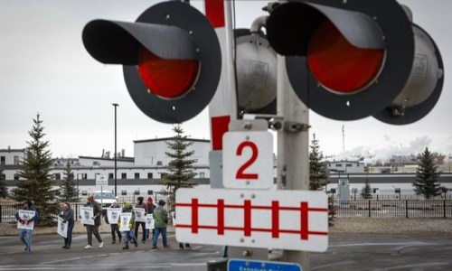 Locked-out workers picket the Canadian Pacific Railway headquarters in Calgary, Alta., Sunday, March 20, 2022.&nbsp;Business leaders who happen to be in the U.S. capital today say they are in damage control mode as a work stoppage at CP Rail deals another blow to cross-border supply chains.THE CANADIAN PRESS/Jeff McIntosh