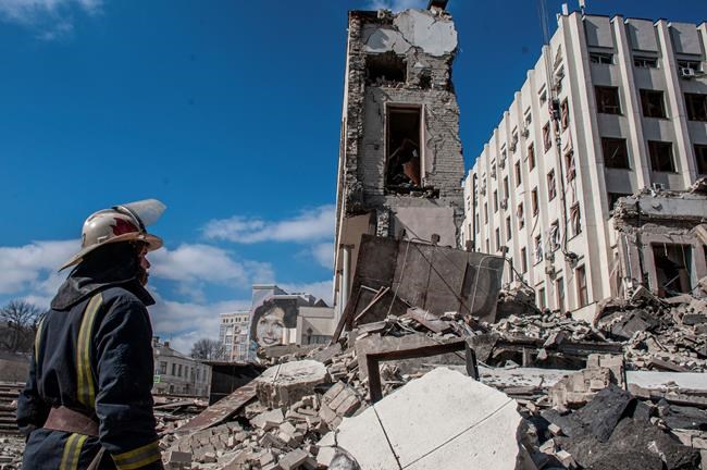 Rescuers work at the site of the National Academy of State Administration building damaged by shelling in Kharkiv, Ukraine, Friday, March 18, 2022. (AP Photo/Andrew Marienko)