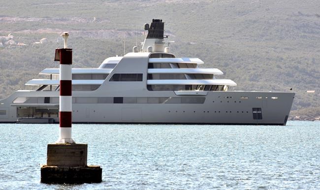 A view of Russian metals and petroleum magnate Roman Abramovich's superyacht Solaris anchored in Tivat, Montenegro, Saturday, March 12, 2022. President Joe Biden has warned Kremlin-aligned oligarchs that the U.S. and its European allies are coming for their superyachts. But actually seizing the behemoth vessels often worth hundreds of millions of dollars could prove challenging. Many of the boats are flagged and registered in secretive banking havens used by the ultra-rich to shield their wealth from taxes or seizures. Abramovich's superyacht Solaris, stands eight stories tall, and features a sleek palisade of broad teak-covered decks suitable for hosting a horde of well-heeled partygoers. (AP Photo/Risto Bozovic)