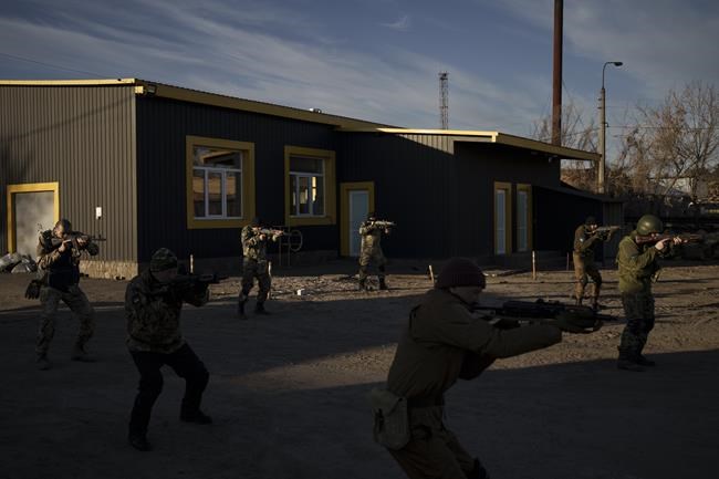 Civilian volunteers attend a training camp of the Ukrainian Territorial Defense Forces in Brovary, northeast of Kyiv, Ukraine, Monday, March 21, 2022. (AP Photo/Felipe Dana)