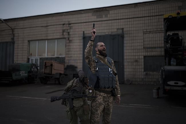 Serhii Volosovets, a commander in the Ukrainian Territorial Defense Forces, fires a pistol during a training camp for volunteers in Brovary, northeast of Kyiv, Ukraine, Monday, March 21, 2022. (AP Photo/Felipe Dana)