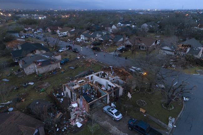 Debris litters the ground surrounding homes, damaged by severe storms reported as tornadoes, on Oxford Drive and Stratford Drive in Round Rock, Texas Monday March 21, 2022. (Jay Janner/Austin American-Statesman via AP)