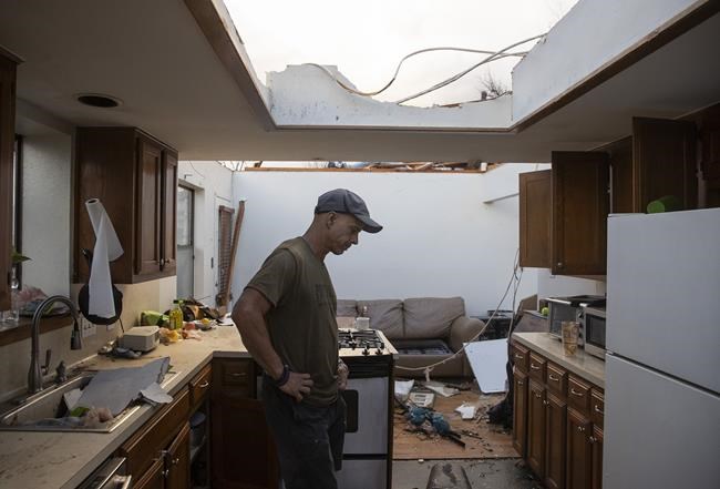 Michael Talamantez looks at his house on Stratford Drive in Round Rock, Texas, after it was destroyed by a tornado while he was inside on Monday March 21, 2022.