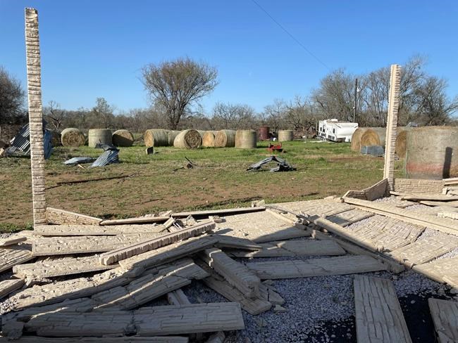 Debris lines the roads as crews and homeowners work to repair properties damaged by severe weather in Elgin, Texas, Tuesday, March 22, 2022. Officials say multiple tornadoes ripped through parts of Texas and Oklahoma on Monday. (AP Photo/Acacia Coronado)
