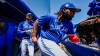 Toronto Blue Jays’ Lourdes Gurriel Jr., left, and Vladimir Guerrero Jr. head to the field at the start of a spring training baseball game at TD Ballpark Tuesday, March 22, 2022, in Dunedin, Fla. THE CANADIAN PRESS/Steve Nesius
