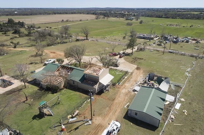 A house on Monkey Road in Elgin, Texas, on Tuesday March 22, 2022, is damaged by a tornado that struck Monday. Multiple tornadoes ripped through parts of Texas and Oklahoma, killing at least one person and causing multiple injuries and widespread damage before the storm system moved on to Louisiana and Mississippi. (Jay Janner/Austin American-Statesman via AP)