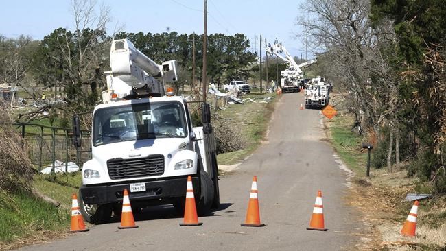 Monkey Road in Elgin, Texas, was closed to through traffic Tuesday, March 22, 2022, as power companies repaired lines downed from the Monday storm. A tornado swept through Bastrop County causing major damage south of Elgin, Texas, Monday March 21. Multiple tornadoes ripped through parts of Texas and Oklahoma, killing at least one person and causing multiple injuries and widespread damage before the storm system moved on to Louisiana and Mississippi. (Nell Carroll/Austin American-Statesman via AP)