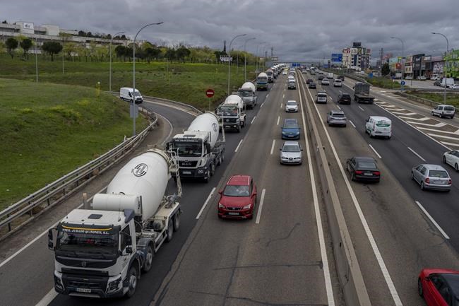 Trucks gather to protest against the high price of fuel in Parla, outskirts of Madrid, Spain, Tuesday, March 22, 2022. European governments are slashing fuel taxes and doling out tens of billions to help consumers, truckers, farmers and others cope with spiking energy prices made worse by Russia’s invasion of Ukraine. (AP Photo/Manu Fernandez)