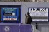 A fan takes a picture of a sign at Chelsea football club's Stamford Bridge stadium in London, Thursday, March 10, 2022. Unprecedented restrictions have been placed on Chelsea’s ability to operate by the British government after owner Roman Abramovich is targeted in sanctions. Abramovich is among seven wealthy Russians who had their assets frozen by the government. (AP Photo/Kirsty Wigglesworth)