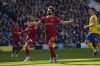 Liverpool's Mohamed Salah celebrates after scoring his side's second goal on a penalty kick during the English Premier League soccer match between Brighton and Hove Albion and Liverpool at the Amex stadium in Brighton, England, Saturday, March 12, 2022. (AP Photo/Kirsty Wigglesworth)