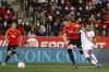 Mallorca's Antonio Raillo, centre, holds off Real Madrid's Rodrygo during a Spanish La Liga soccer match between Mallorca and Real Madrid in Palma de Mallorca, Spain, Monday, March 14, 2022. (AP Photo/Francisco Ubilla)