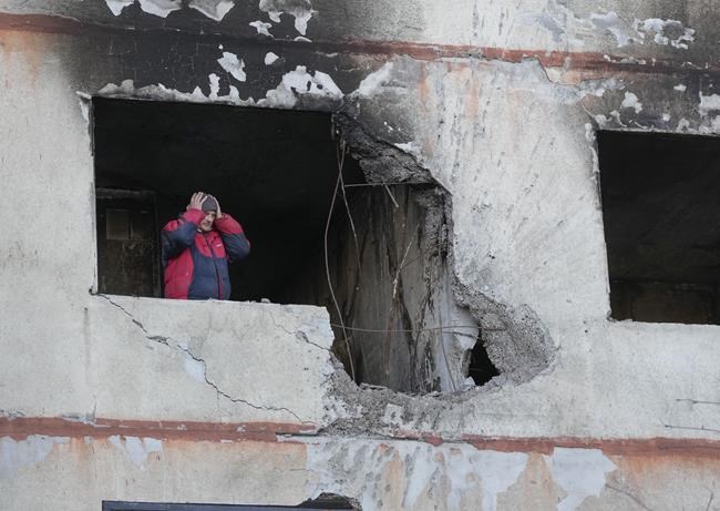 A man holds his head as he stands in his apartment in a multi-story house that was destroyed following a Russian attack in Kharkiv, Ukraine, Thursday, March 24, 2022. (AP Photo/Efrem Lukatsky)