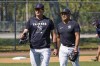 New York Yankees infielders Josh Donaldson, left, and Isiah Kiner-Falefa walk off the field after fielding practice during a spring training baseball workout, Monday, March 14, 2022, in Tampa, Fla. (AP Photo/John Raoux)