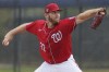 Washington Nationals pitcher Stephen Strasburg throws live batting practice in a drizzle during the team's spring training baseball workout, Tuesday, March 15, 2022, in West Palm Beach, Florida. (AP Photo/Sue Ogrocki)