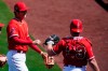 Los Angeles Angels pitcher Shohei Ohtani, left, of Japan, gives catcher Max Stassi, right, a fist-bump after getting the Kansas City Royals out during the second inning of a spring training baseball game Monday, March 21, 2022, in Tempe, Ariz. (AP Photo/Ross D. Franklin)