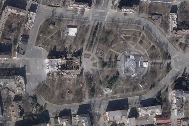 In this satellite photo from Planet Labs PBC, the Donetsk Academic Regional Drama Theater, center left, that had been sheltering those fleeing Russia's war on Ukraine is seen in ruins in Mariupol, Ukraine, Monday, March 21, 2022. The theater had been bombed by Russia amid the war despite a large warning in Cyrillic in the front and back of the theater reading,