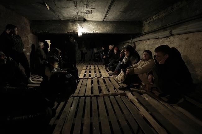 People shelter underground following explosions in Lviv, western Ukraine, Saturday, March 26, 2022. With Russia continuing to strike and encircle urban populations, from Chernihiv and Kharkiv in the north to Mariupol in the south, Ukrainian authorities said Saturday that they cannot trust statements from the Russian military Friday suggesting that the Kremlin planned to concentrate its remaining strength on wresting the entirety of Ukraine's eastern Donbas region from Ukrainian control. (AP Photo/Nariman El-Mofty)