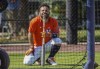 Houston Astros second baseman Jose Altuve rests his head on his bat as he watches batting practice during spring training baseball workouts Monday, March 21, 2022, in West Palm Beach, Fla. (Karen Warren/Houston Chronicle via AP)