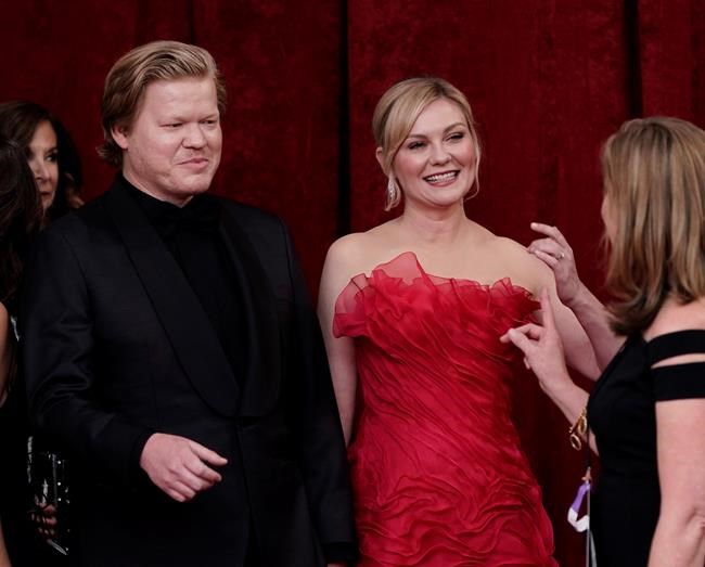 Jesse Plemons, left, and Kirsten Dunst arrive at the Oscars on Sunday, March 27, 2022, at the Dolby Theatre in Los Angeles. (AP Photo/Jae C. Hong)