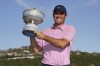 Scottie Scheffler holds the trophy after winning the Dell Technologies Match Play Championship golf tournament, Sunday, March 27, 2022, in Austin, Texas. (AP Photo/Tony Gutierrez)