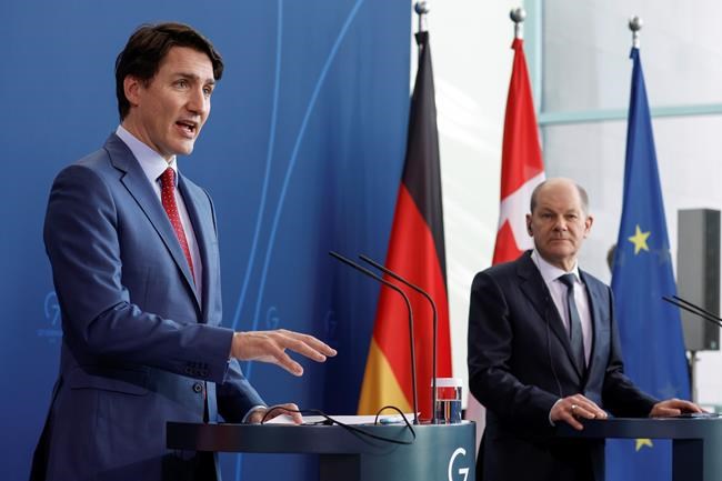 German Chancellor Olaf Scholz, right, and Canadian Prime Minister Justin Trudeau address a press conference at the Chancellery in Berlin after talks on Wednesday, March 9, 2022. The Prime Minister says that while the Russian invasion may be driving up energy prices, it is still providing the impetus to drive western economies towards developing greener energy sources. THE CANADIAN PRESS/Odd Andersen/Pool via AP