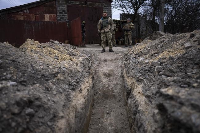 A soldier stands near a long trench built by Ukrainian army near the front line in Brovary, on the outskirts of Kyiv, Ukraine, Monday, March 28, 2022. (AP Photo/Rodrigo Abd)