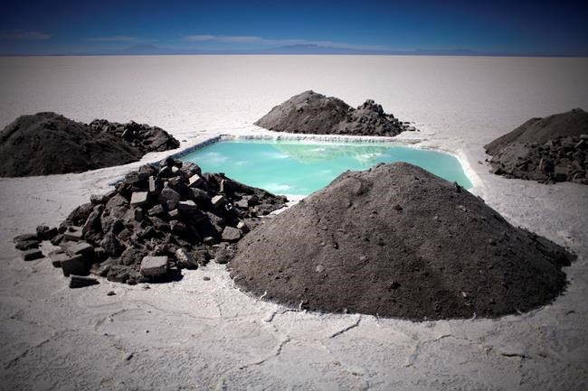 FILE - An evaporation pond used to measure lithium and other minerals levels sits in the Uyuni salt desert near Colchani, Bolivia on Monday July 26, 2010. The salt flats of Uyuni have triggered international interest among energy companies due to its lithium reserves and Bolivia hopes the metal could power a green revolution when electric cars reach mass production. (AP Photo/Dado Galdieri, File)