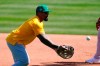 Oakland Athletics first baseman Eric Thames flips the ball to first base during a spring training baseball workout Wednesday, March 16, 2022, in Mesa, Ariz. (AP Photo/Ross D. Franklin)