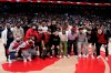 The Canadian men's national soccer team pose for a photo on the court during a break in play during first half NBA basketball action between the Toronto Raptors and the Boston Celtics, in Toronto, Monday, March 28, 2022. THE CANADIAN PRESS/Frank Gunn