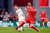 Denmark's Christian Eriksen, left, and Serbia's Strahinja Pavlovic battle for the ball during the international friendly soccer match between Denmark and Serbia in the Park, Copenhagen, Tuesday March 29, 2022. (Liselotte Sabroe/Ritzau Scanpix via AP)