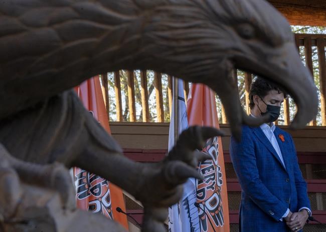 Prime Minister Justin Trudeau is framed by a eagle statue as he visits Tk’emlups te Secwepemc in Kamloops, B.C. Monday, Oct. 18, 2021. THE CANADIAN PRESS/Jonathan Hayward